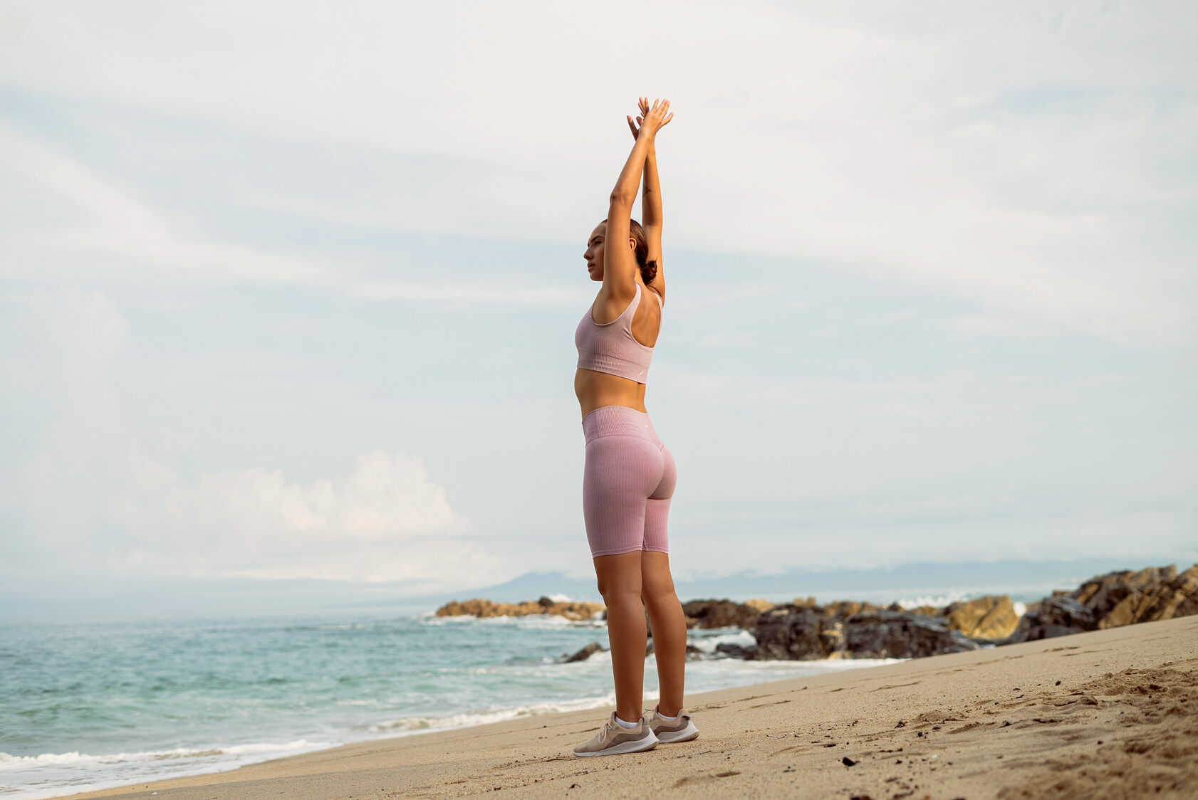 Fit Woman Stretching on Beach